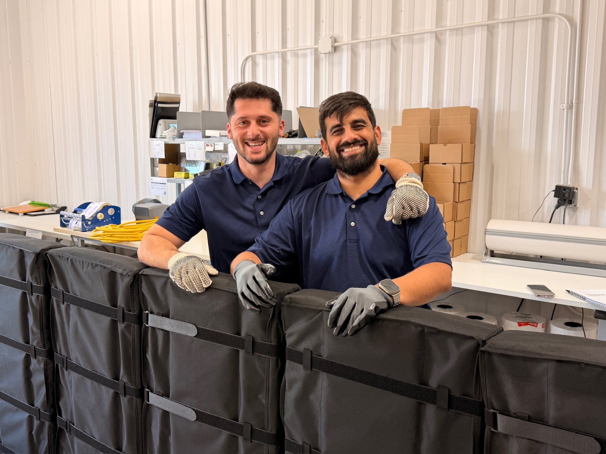The team in our warehouse with panels ready to ship